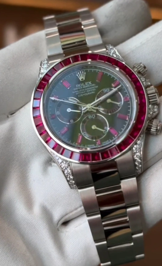 Rolex Cosmograph Daytona in 18K white gold with a ruby and diamond bezel and custom diamond-set lugs.