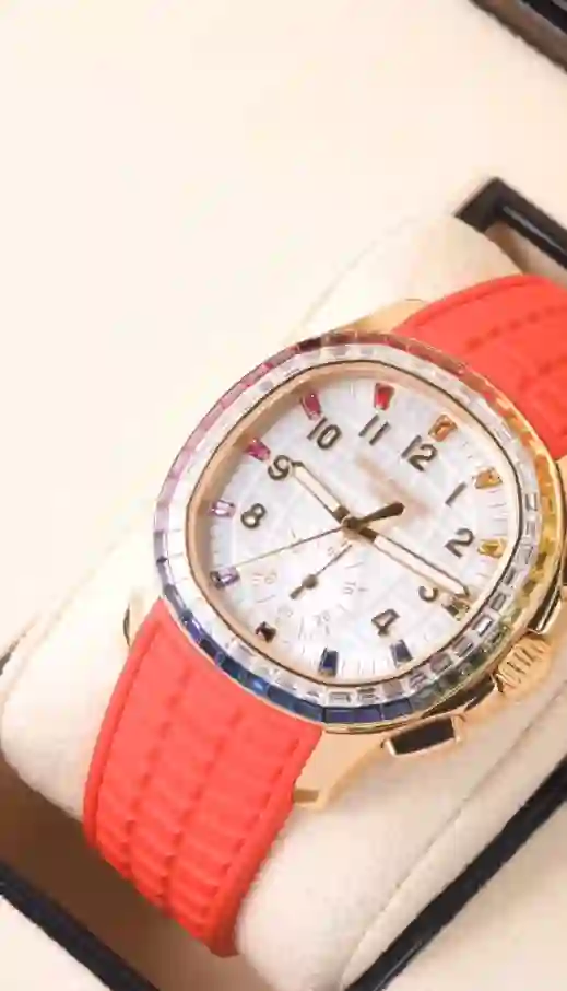 Patek Philippe Aquanaut Luce Rainbow Flyback Chronograph with a red strap