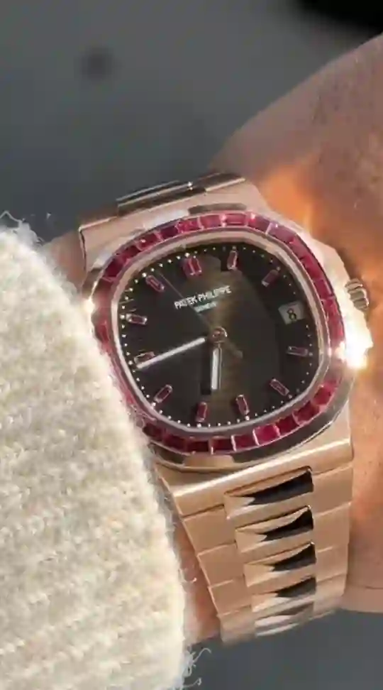a Patek Philippe Nautilus 5723/112R rose gold watch with a baguette ruby bezel.