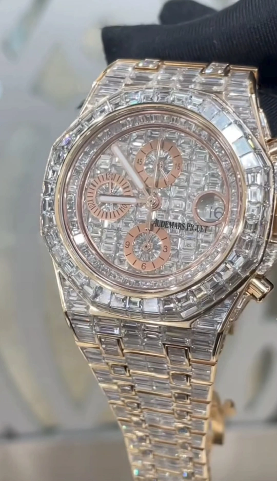 a custom fully iced-out Audemars Piguet Royal Oak in 18K rose gold with baguette-cut diamonds.